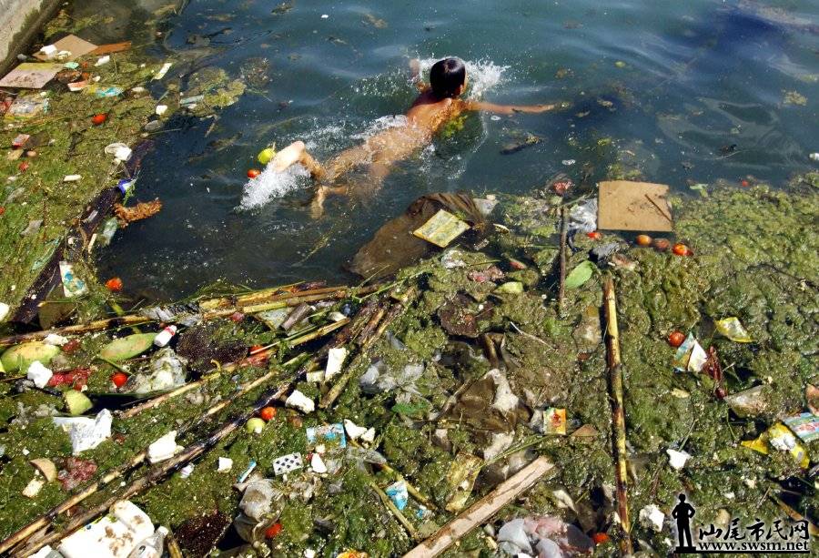 a-child-swims-in-a-polluted-reservoir-southwest-of-chinas-guizhou-province-in-se.jpg